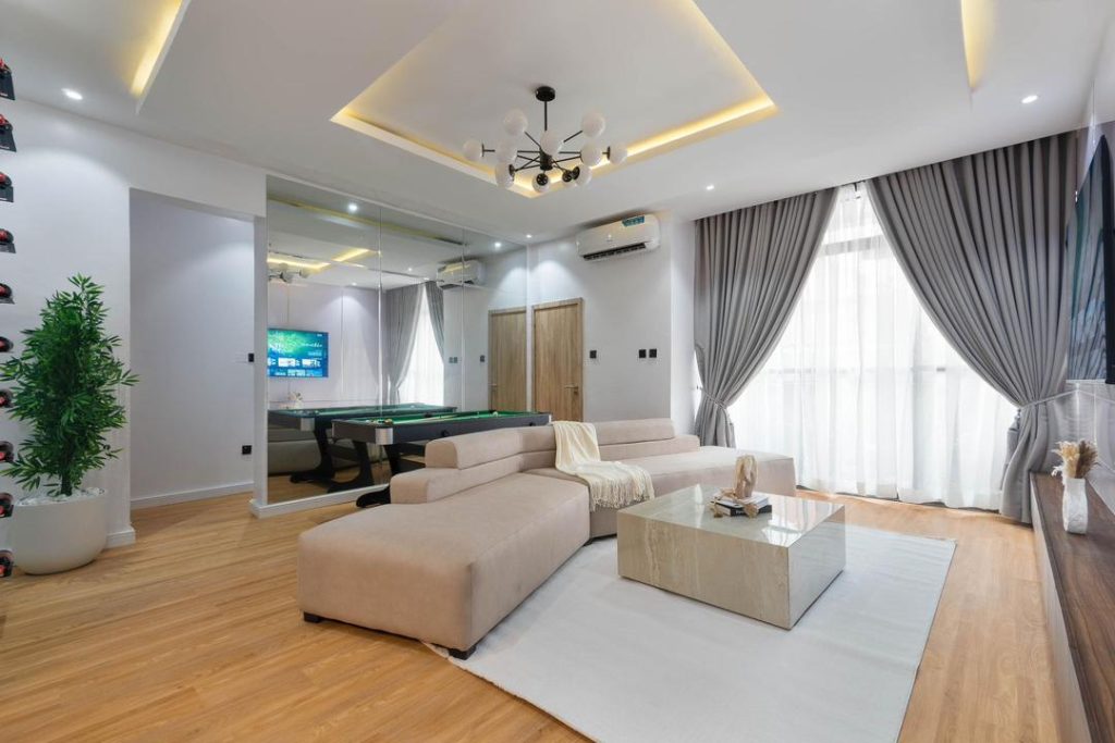 Living room of a furnished Lagos short-let apartment with a large sectional sofa and coffee table