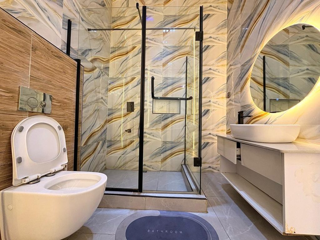 Clean bathroom in a furnished short-let apartment with towels and fittings in place