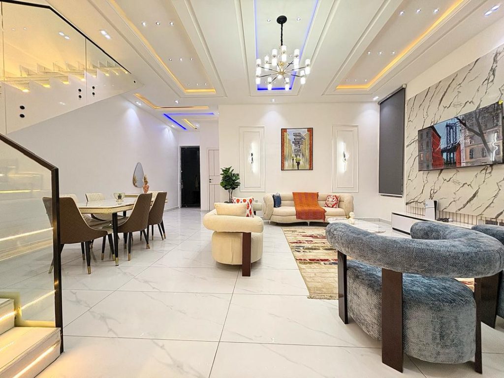 Wide open-plan living and dining area in a Lagos short-let apartment, the kind of frame that works as a listing cover image